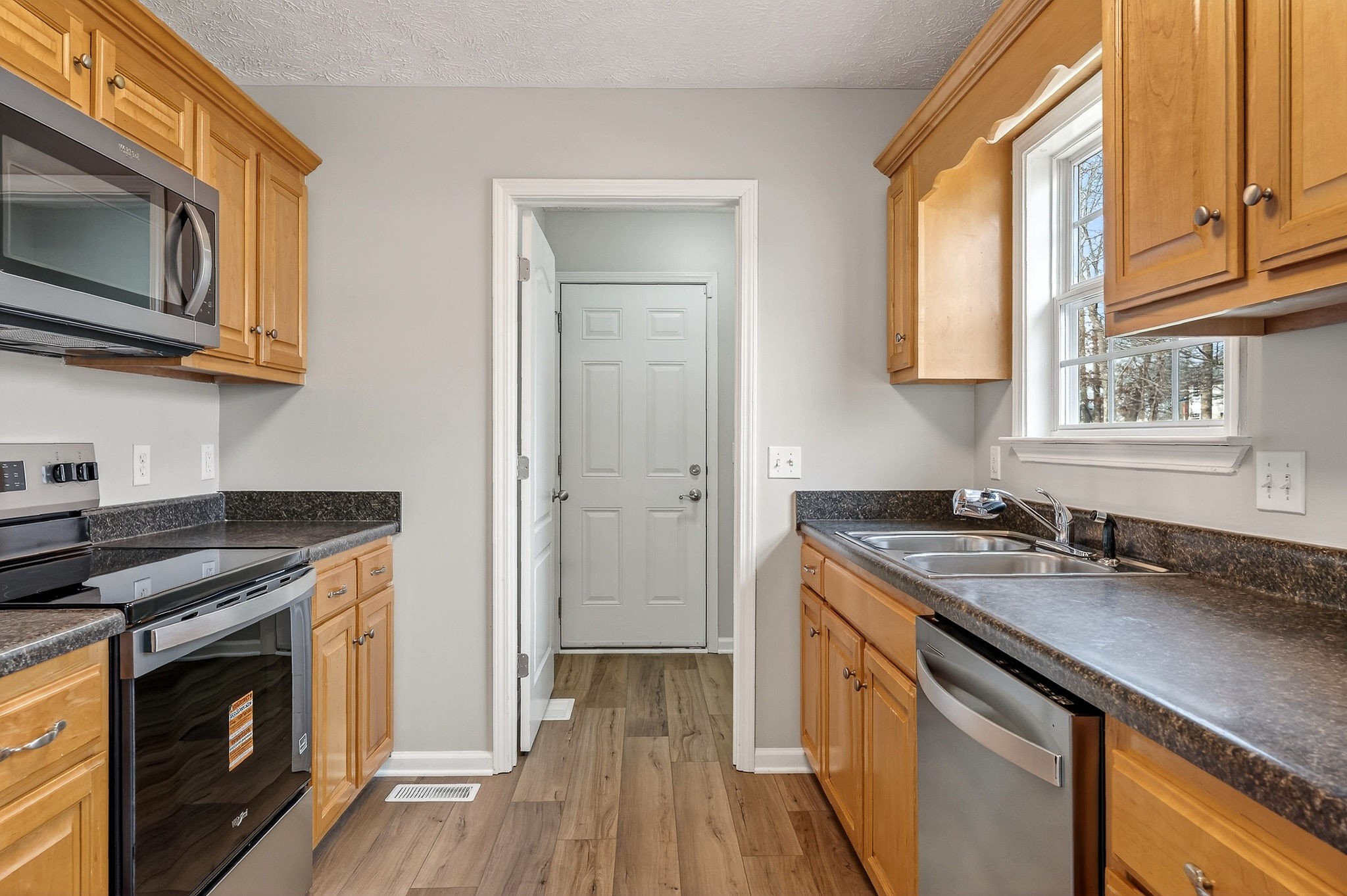 325 Indian Springs Circle Manchester, TN 37355 - Photo 8 of 29 a kitchen with stainless steel appliances granite countertop a sink stove and microwave