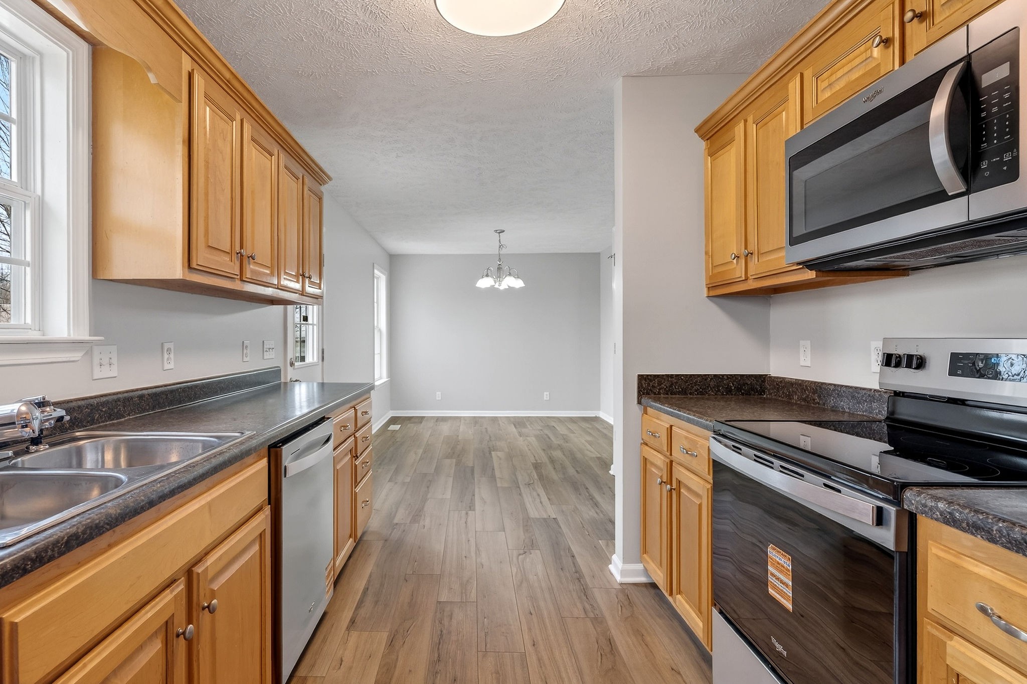 325 Indian Springs Circle Manchester, TN 37355 - Photo 9 of 29 a kitchen with stainless steel appliances granite countertop wooden cabinets stove top oven and sink