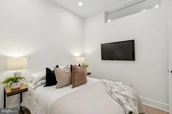 a bedroom with a bed and a flat screen tv