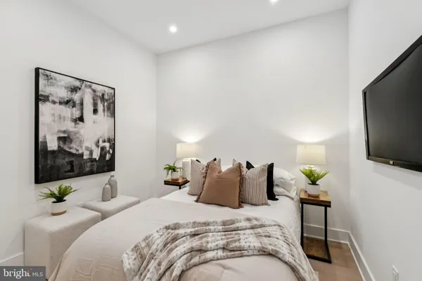 a bedroom with a bed and a flat screen tv