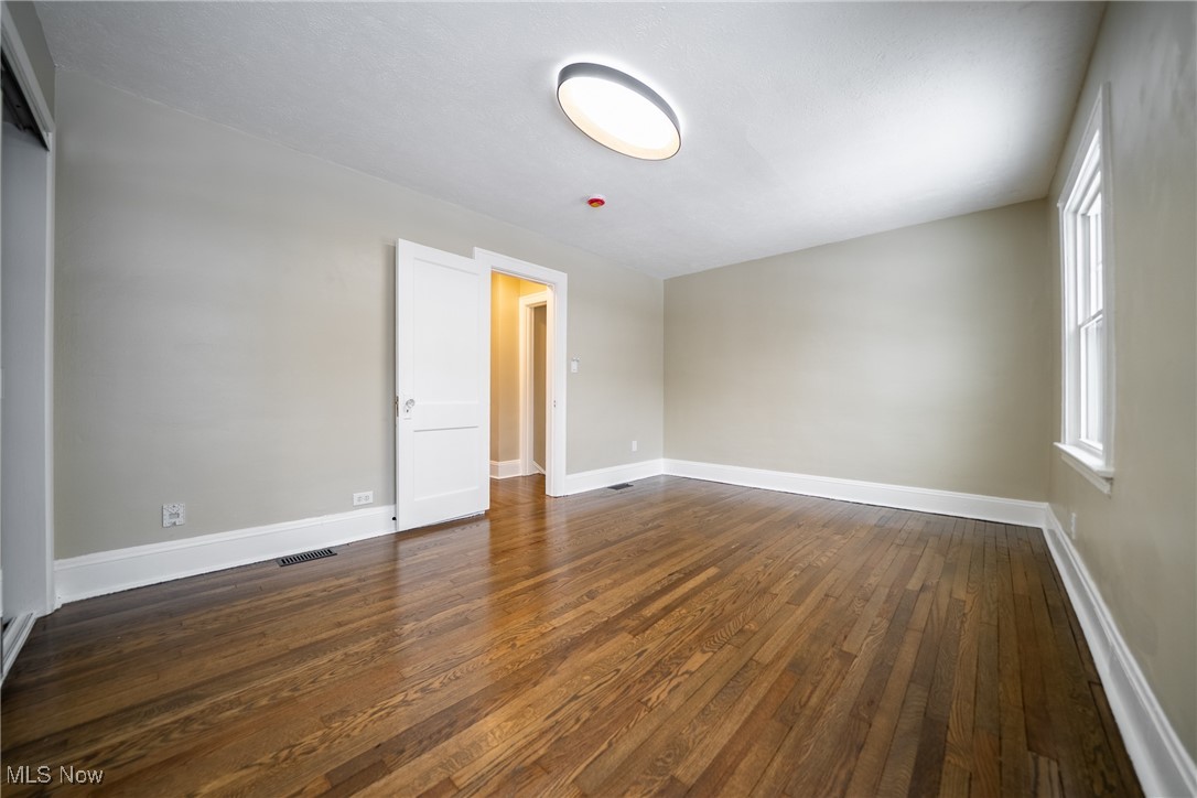 3816 Summit Park Road Cleveland Heights, OH 44121 - Photo 16 of 35 Unfurnished room featuring dark wood-style floors and baseboards