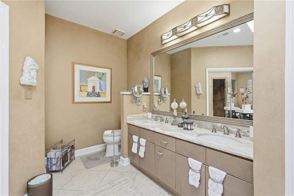 5264 Brooke Ridge Drive Dunwoody, GA 30338 - Photo 18 of 47 a bathroom with a granite countertop toilet sink and mirror