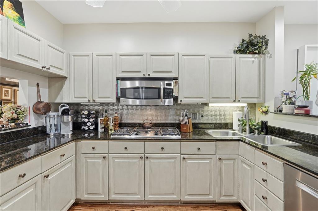 5264 Brooke Ridge Drive Dunwoody, GA 30338 - Photo 24 of 47 a kitchen with granite countertop white cabinets and white appliances