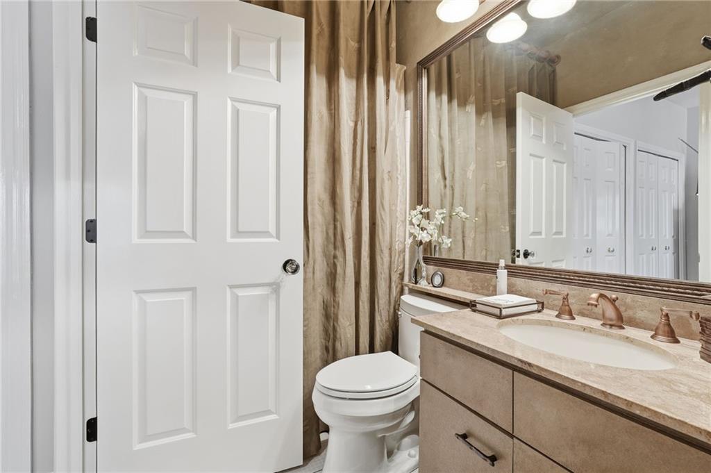 5264 Brooke Ridge Drive Dunwoody, GA 30338 - Photo 30 of 47 a bathroom with a granite countertop sink toilet and shower