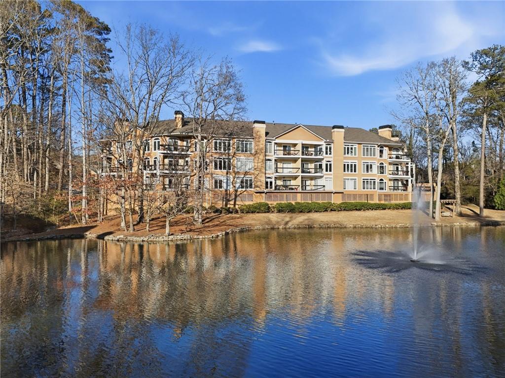 5264 Brooke Ridge Drive Dunwoody, GA 30338 - Photo 32 of 47 a view of a lake with a building in the background