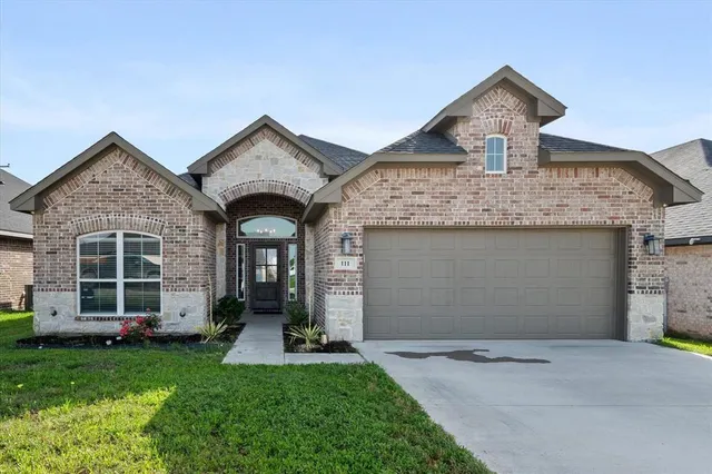 front view of a house with a yard