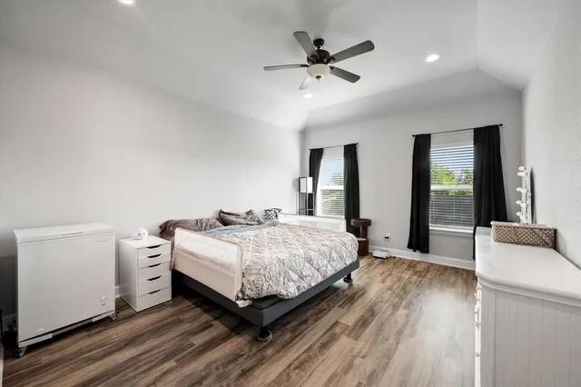 a spacious bedroom with a bed and a fireplace