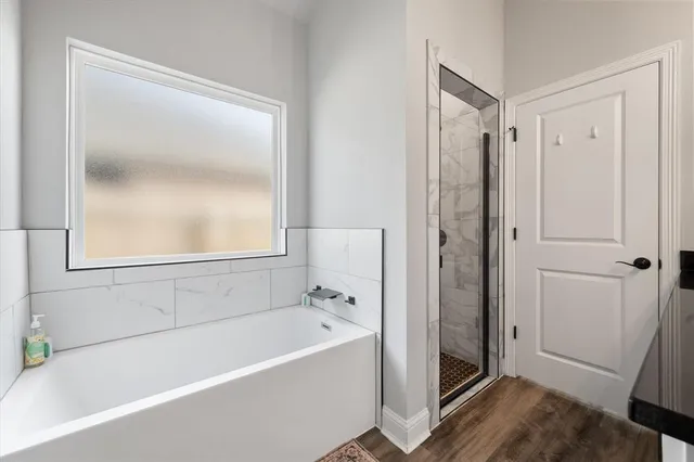 a white bath tub sitting next to a window