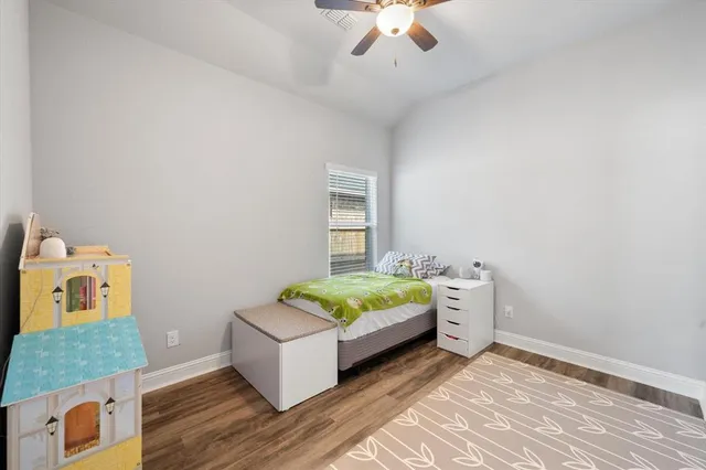 a bathroom with a granite countertop toilet sink and mirror