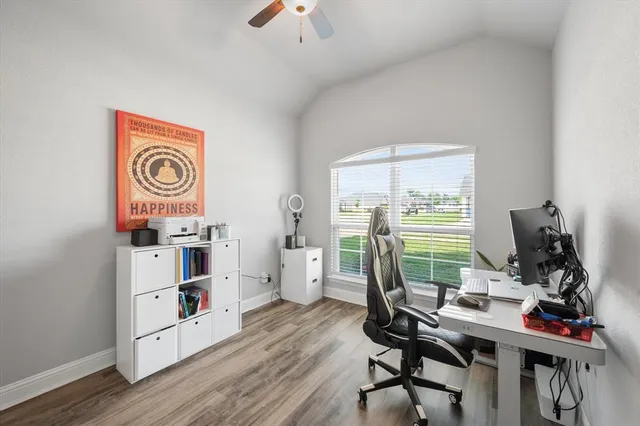 a view of a workspace with furniture and a window