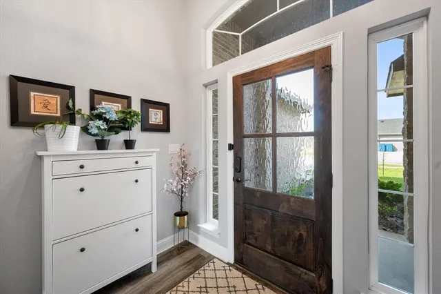 a living room with stainless steel appliances furniture and a view of kitchen