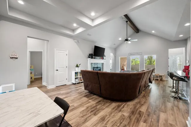 a living room with furniture and kitchen view