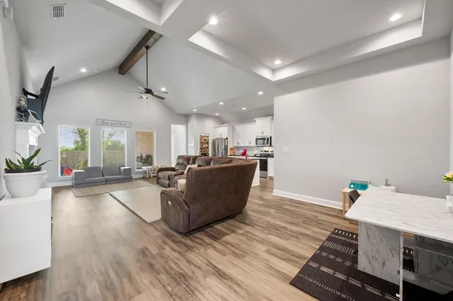 a kitchen with kitchen island granite countertop stainless steel appliances cabinets a sink and a counter top space