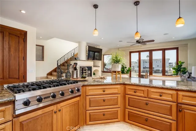 a living room with furniture kitchen view and a large window