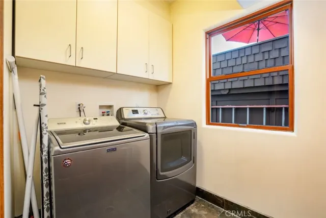 a living room with furniture potted plant floor and a flat screen tv