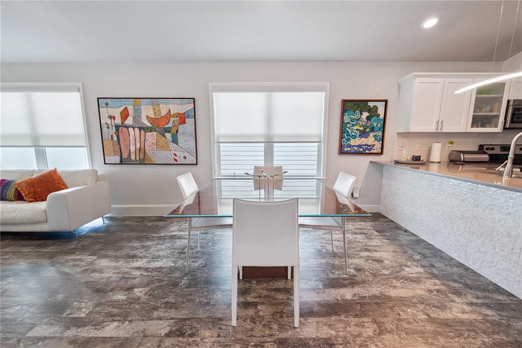 1790 Southwest 247th Street Newberry, FL 32669 - Photo 13 of 44 a living room with stainless steel appliances granite countertop furniture a couch a window and a bookshelf