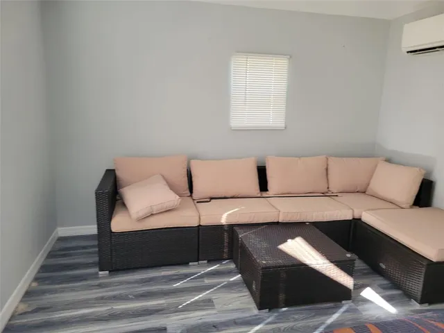 a living room with a couch and a wooden floor