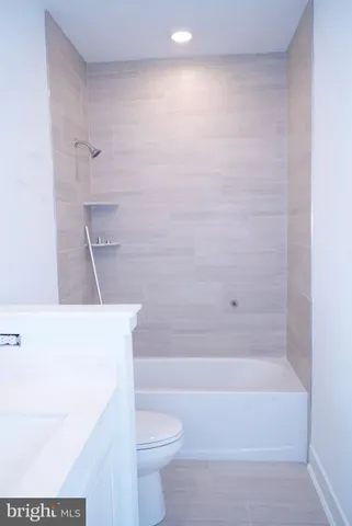 a bathroom with a sink a toilet and bathtub