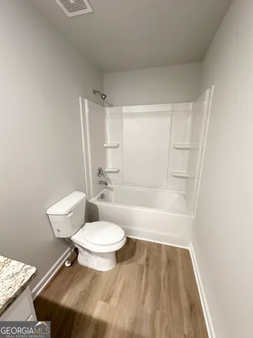 a bathroom with a toilet a sink and bathtub