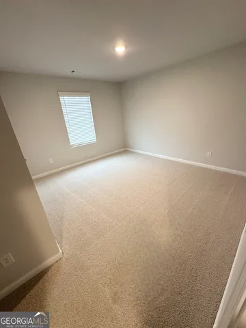 an empty room with a empty space and windows