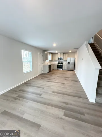 a view of a room with window and hardwood floor