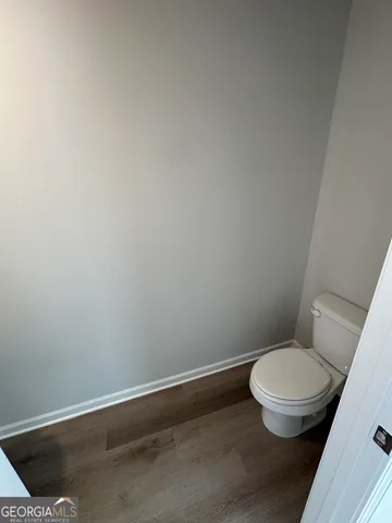 a white toilet sitting next to a shower