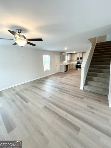 a view of an empty room and wooden floor