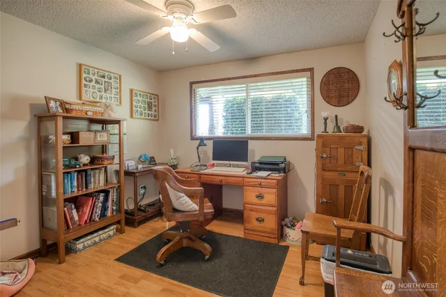 a view of a workspace with furniture and a window