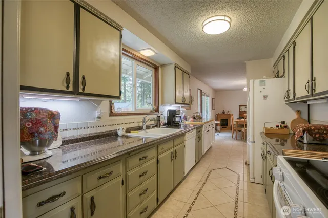 a kitchen with sink and cabinets