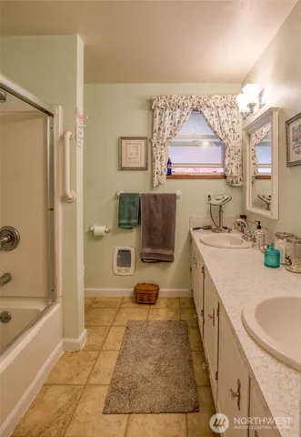 a bathroom with a tub a sink and a large mirror