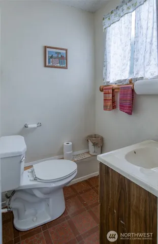 a white toilet sitting next to a bathroom sink