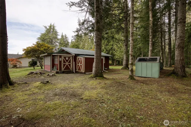 a view of a house with backyard and a tree
