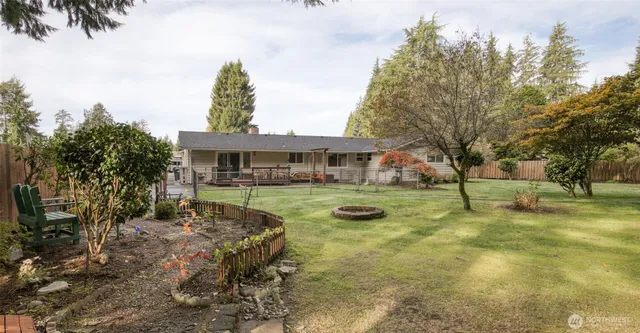 a front view of a house with yard and green space