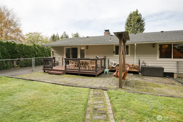 a view of a house with swimming pool and sitting area
