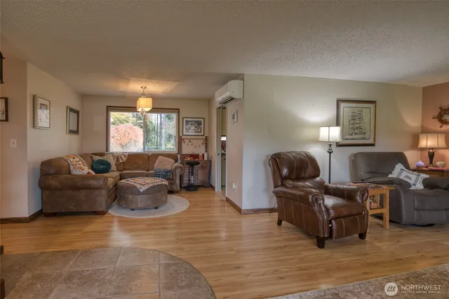 a living room with furniture and a hard wood floor