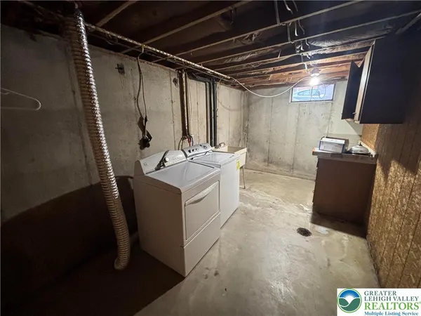 a utility room with faucet washer and dryer