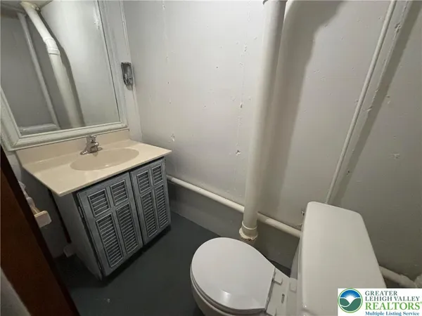 a bathroom with a toilet a sink and a mirror