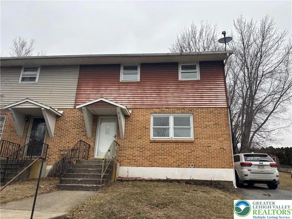 a front view of a house with parking