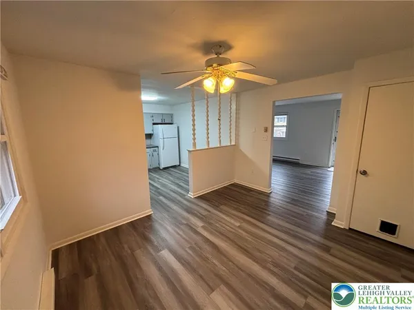a view of empty room with wooden floor