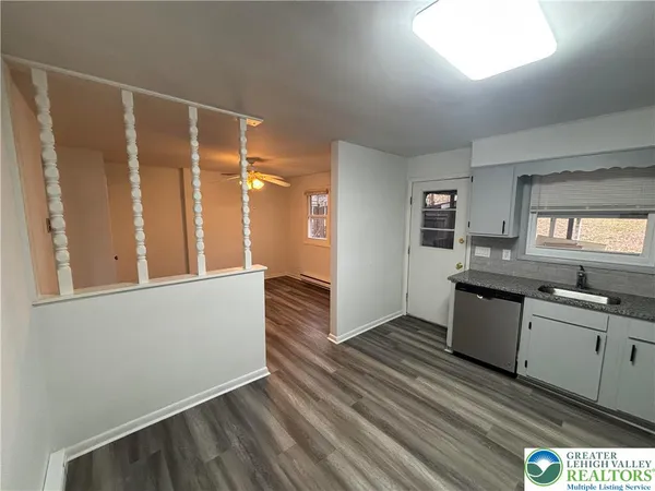 a kitchen with granite countertop a sink and cabinets
