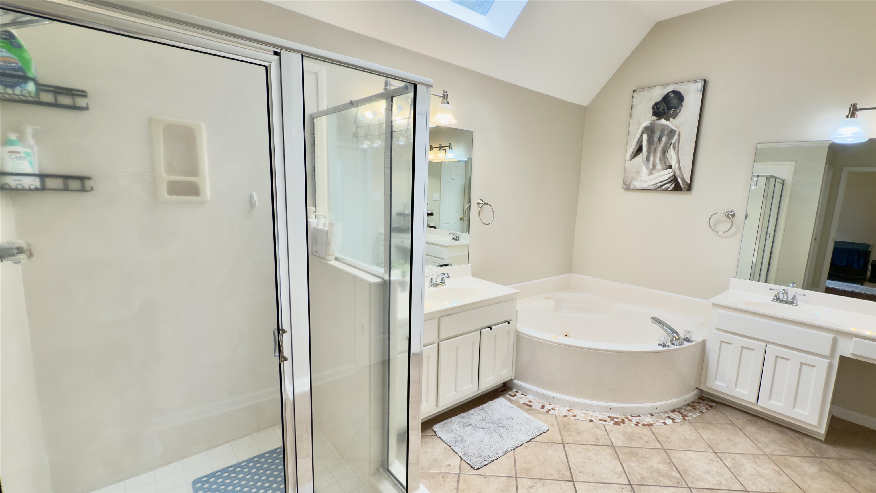 1082 Sugar Lane Collierville, TN 38017 - Photo 12 of 25 a bathroom with a white tub shower vanity and a sink