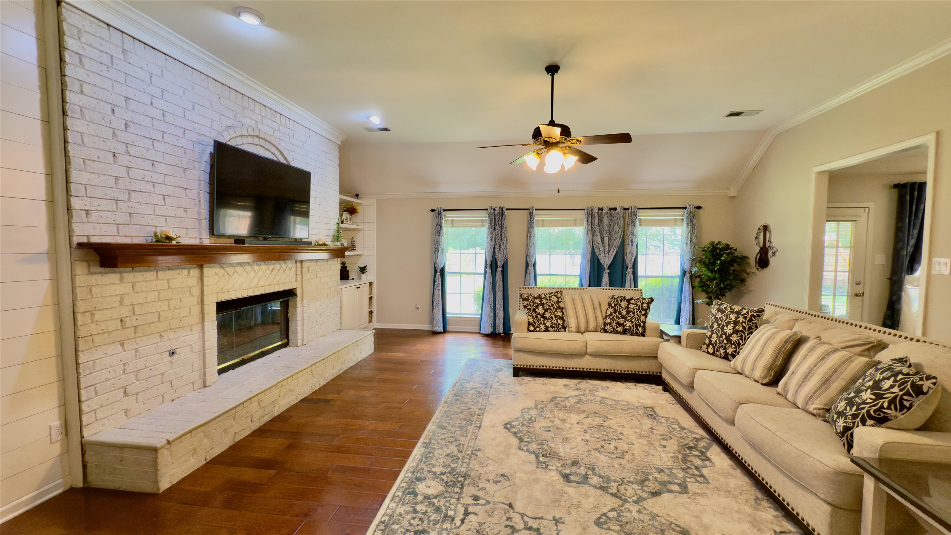 1082 Sugar Lane Collierville, TN 38017 - Photo 4 of 25 a living room with furniture a flat screen tv and a fireplace
