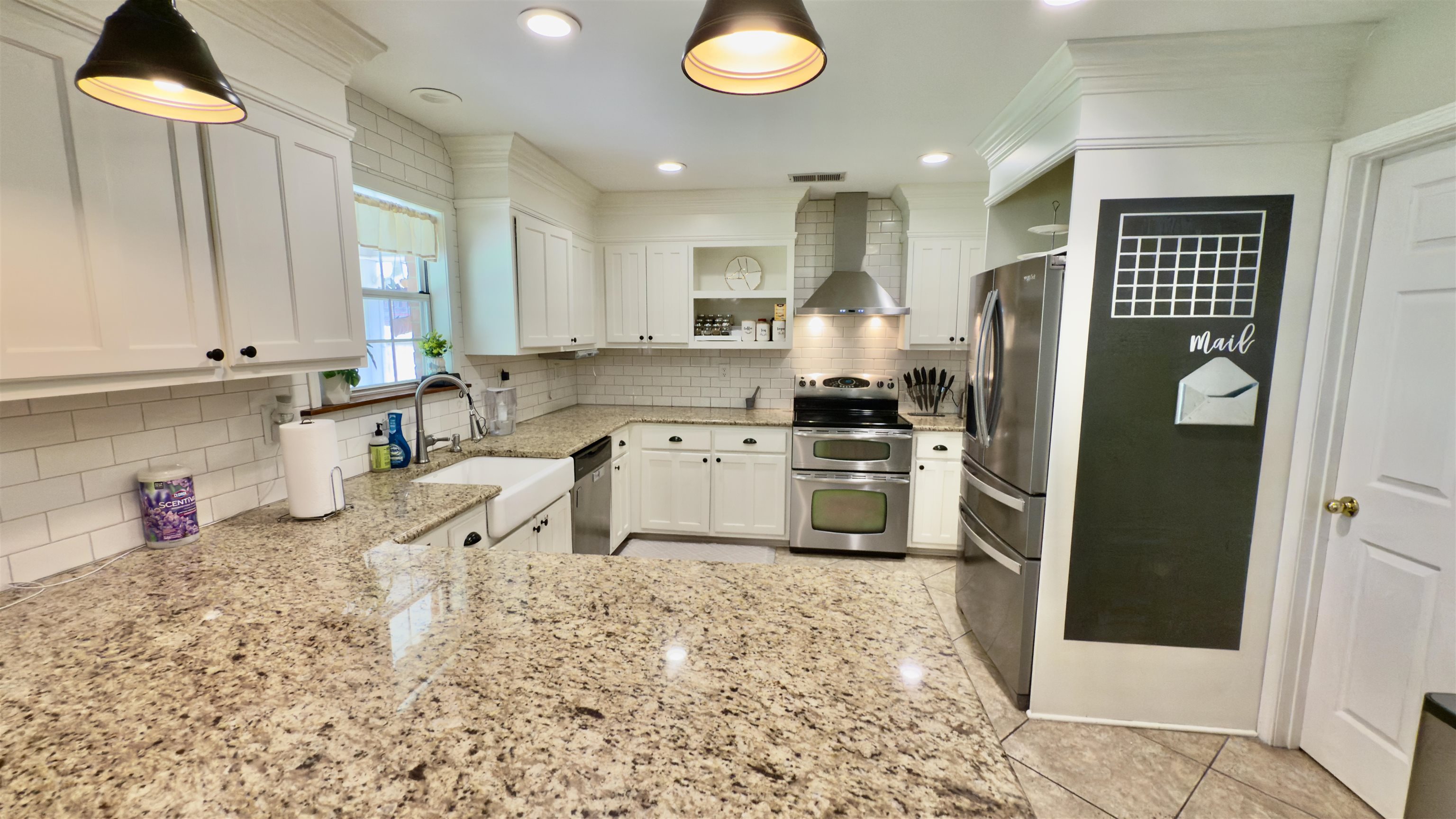 1082 Sugar Lane Collierville, TN 38017 - Photo 10 of 25 a kitchen with stainless steel appliances granite countertop a refrigerator sink and cabinets