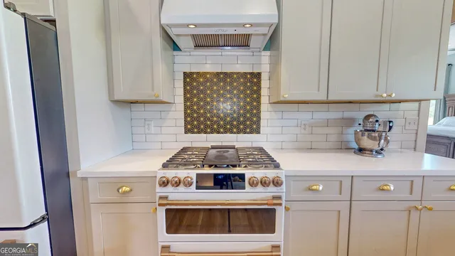 a kitchen with a stove and cabinets