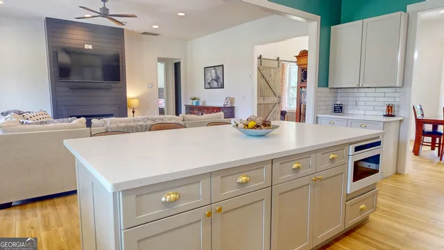 a kitchen with a sink a stove and cabinets