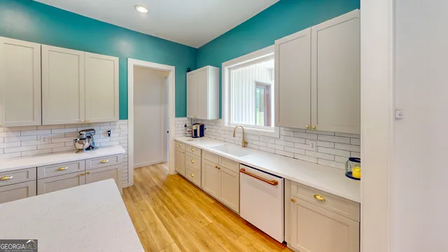 a spacious bathroom with a double vanity sink a mirror and a bathtub