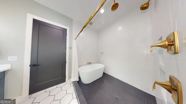 a bathroom with a bathtub and shower