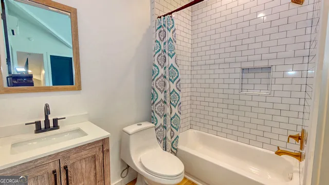 a bathroom with a sink a toilet and bathtub