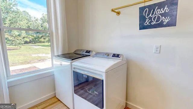 a view of kitchen with a sink microwave and cabinets