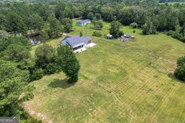 an aerial view of a house with a yard